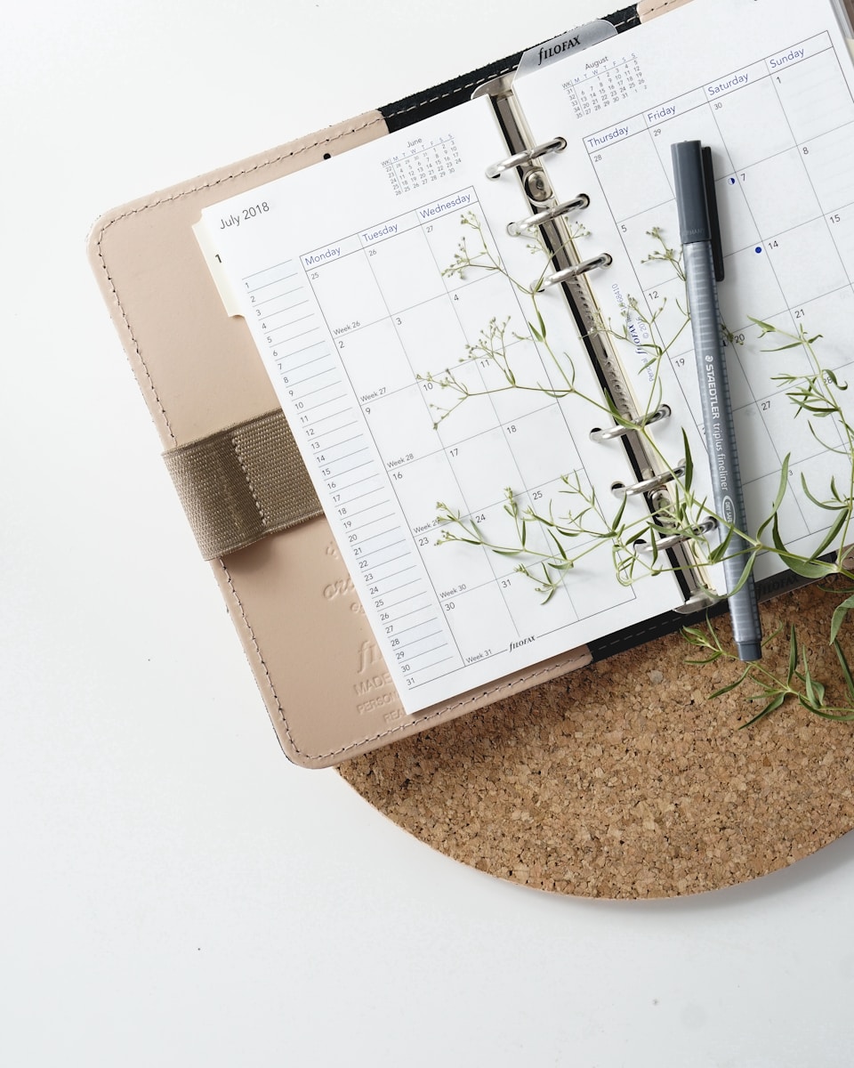 grey and black pen on calendar book symbolizing annual insurance coverage review